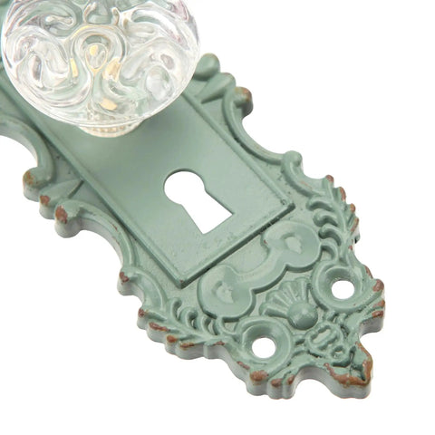 Close-up of a 2 Pack Vintage Cabinet Knob Set With Distressed Pewter Finish And Clear Resin Knob, decorative green base detail.
