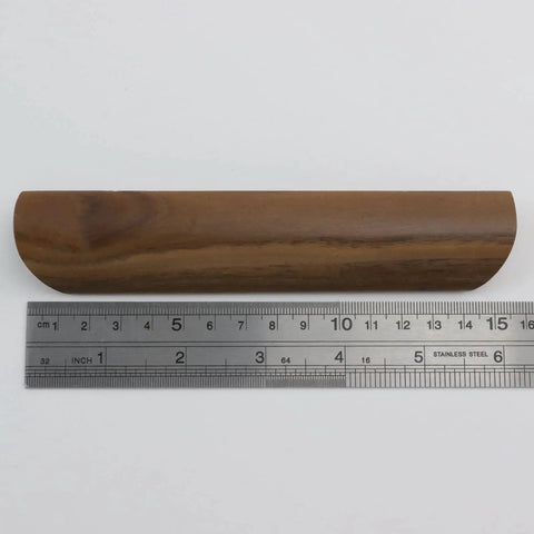 Single walnut wood drawer pull shown with ruler to highlight 157mm length, part of Walnut Wood Drawer Pulls Set Of 6 Solid Wood Furniture Handles With 5.04 Inch Hole Centers 128mm And 6.18 Inch Length 157mm 1.10 Inch Width 28mm Includes Mounting Screws For Dresser And Wardrobe Cabinets Elegant Minimalist Hardware.