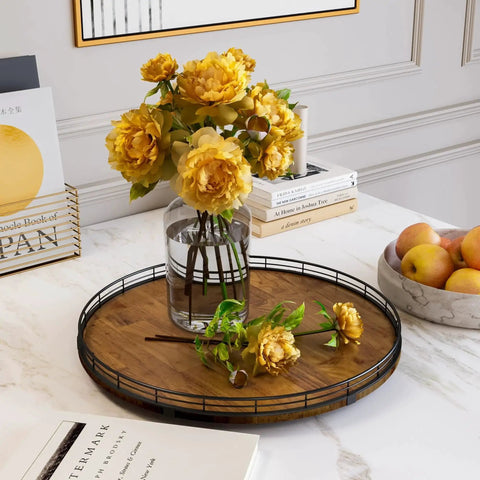 Walnut Wood 18 Inch Lazy Susan Turntable Organizer on a countertop with vase of yellow flowers, books, and a bowl of apples