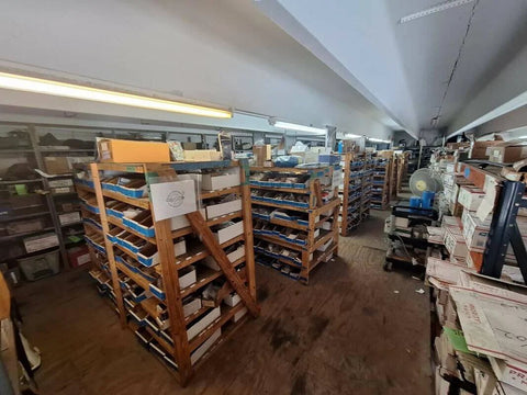 Warehouse shelves with marine products, including 777-9001 Marine Pulley Driven Flexible Impeller Pedestal Mount Pump, parts visible
