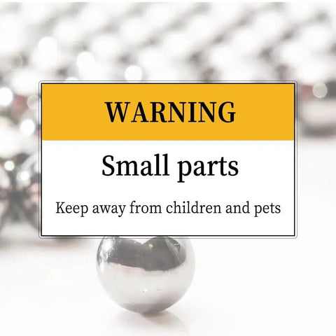 Close-up of Hundred Piece Set Of Three Eighth Inch Hardened Chrome Steel Bearing Balls for DIY with warning about small parts.
