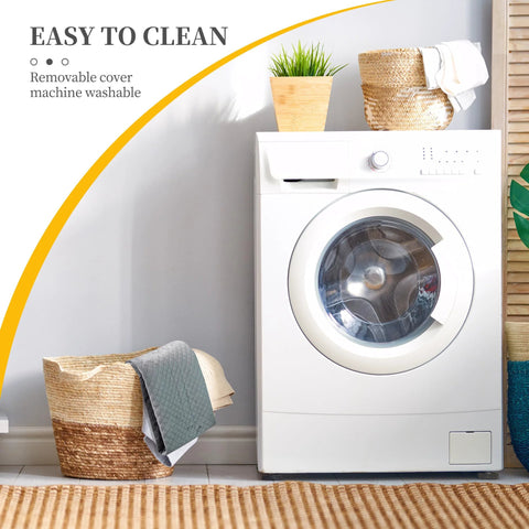 White front-load washing machine in a laundry room with wicker basket, folded towels, and a potted plant.