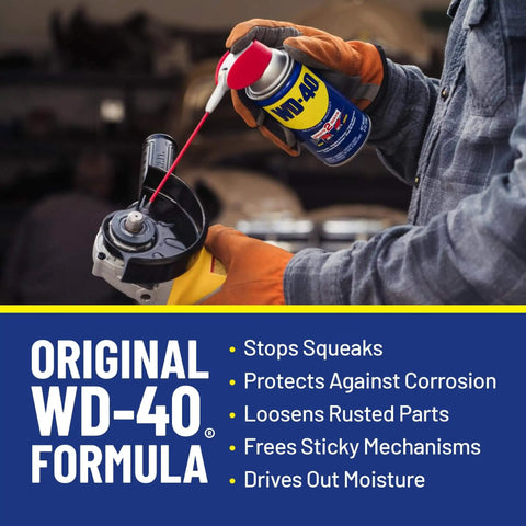 Person applying WD-40 Classic Formula on a tool to prevent corrosion and moisture, showcasing All Purpose Lubricant That Drives Out Moisture and Fights Rust.