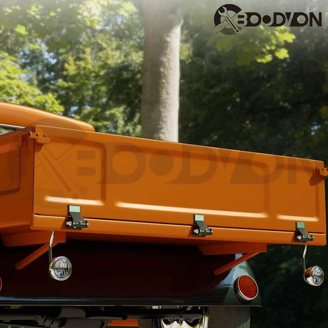 Rear view of a truck with Weld On Trailer Hinges With Grease Fitting Short Leaf Heavy Duty Dump Trailer Hinges installed.