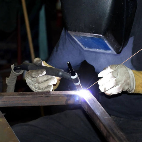 Person using Forty Pack Phos Copper Brazing Rods BCuP-2 with welding torch on metal, protective gear visible