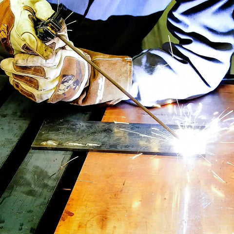 Person welding with Three Thirty Second Inch E6013 Welding Rod 5 Pound All Position for Easy Wetting and Smooth Beads, low spatter.