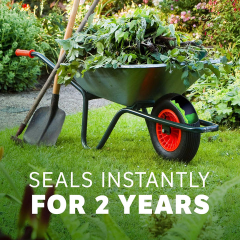 Wheelbarrow in garden with shovel and plants, featuring Slime 10193 Tire and Tube Sealant Puncture Repair Sealant, 16oz bottle seal.
