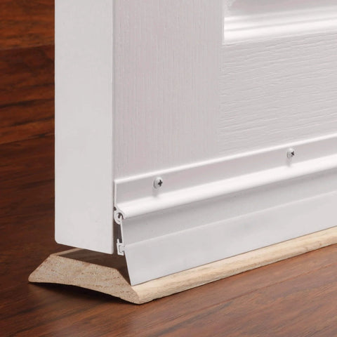 36 in. White Aluminum and Vinyl Flex-O-Matic Screw-on Door Sweep installed on wooden floor, sealing draft under a door.