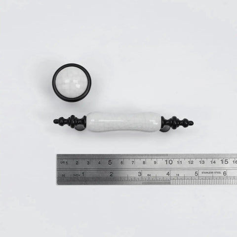 Eight Piece Crack Pattern White Ceramic Cabinet Pulls And Drawer Knobs Set in Antique Black with ruler for scale