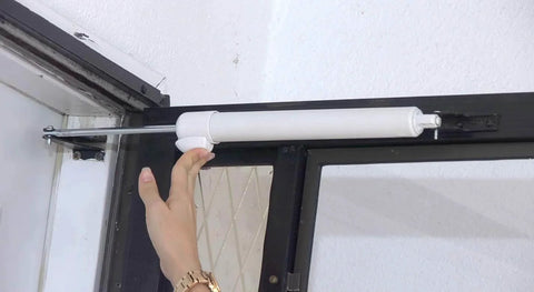 Smooth Door Closer - Single Kit (White) installed on screen door with touch-button hold open feature, demonstrating smooth closing motion.