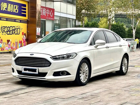 Ford Fusion 2013 white car parked in urban setting, showcasing sleek design and chrome front grille.
