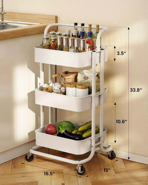Three Tier Mesh Rolling Utility Cart With Handle And Lockable Wheels For Kitchen Office And Living Room White Finish Pipishell Metal Storage Cart With Versatile Shelves For Easy Organization next to kitchen counter.