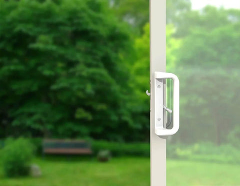 White Patio Door Handle Set with Mortise installed on glass sliding door, showcasing 3-15/16” screw hole spacing and modern design in garden setting.