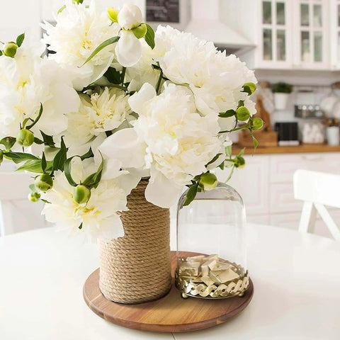 18 inch acacia wood lazy susan cabinet organizer with flowers and decorative items on a table in a kitchen setting.