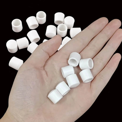 Hand holding several pieces from 25 Pack Door Stop Tips Caps 0.39 Inch White Rubber Universal Replacement Bumpers