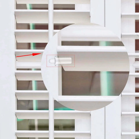 Close-up of white plantation shutter with 40 Pieces Shutter Repair Pins, Plantation Shutter Fasteners Spring Loaded Replacement Repair Pins for windows.