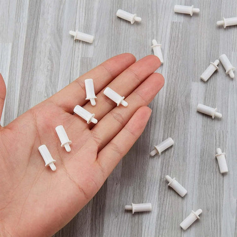 Hand holding white 40 Pieces Shutter Repair Pins, Plantation Shutter Fasteners Spring Loaded Replacement Repair Pins for window and cabinet slats.