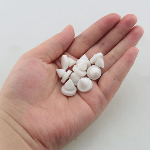 25 Pack Rubber Door Silencers in hand, half inch diameter, odorless silicone for metal doors, white, anti collision cushions