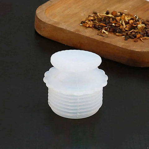 White Silicone Spiral Screw Thermal Sealed Stopper For Home Vacuum Flasks And Water Bottles on black surface next to spices.