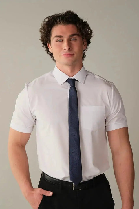 Man wearing Slim Fit Short Sleeve Performance Dress Shirt For Men White 4 Way Stretch comfort with navy tie, suitable for office and travel.
