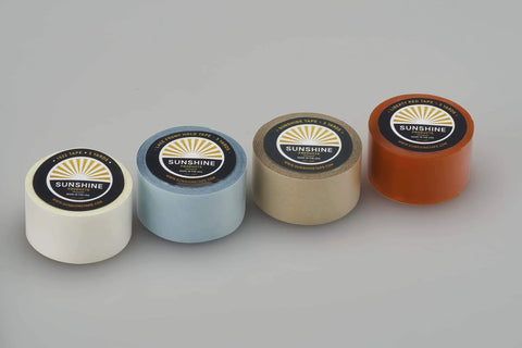 Four rolls of wig tape in various colors with labels, Double Sided Wig Tape You Can Rely On For Daily Wear, Holds Wigs And Hair Systems