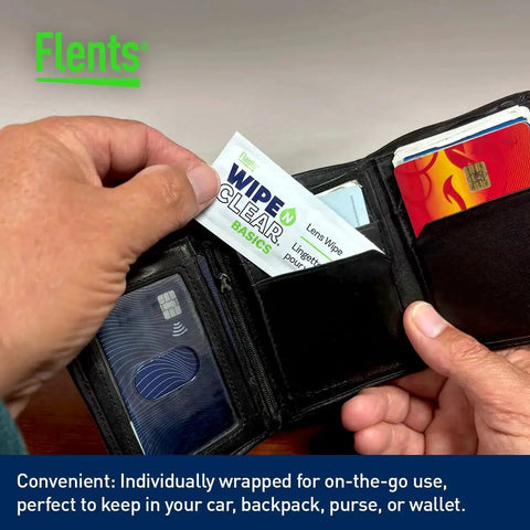 Person holding Wipe N Clear Basic Lens Wipes 100 Count Individually Wrapped for Travel in a wallet with credit cards.