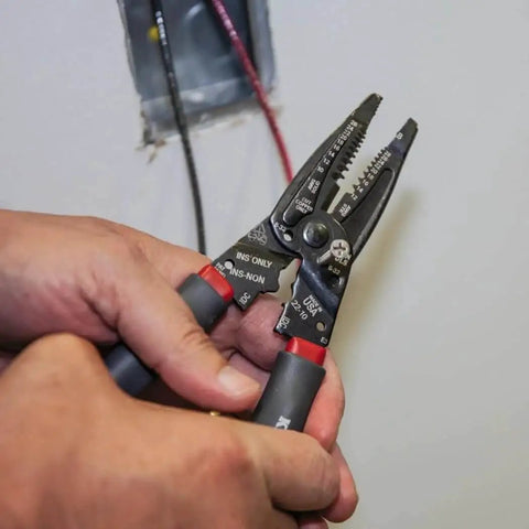 Person using Kurve Wire Stripper Crimper Cutter Multi Tool For 10-26 AWG Solid And 12-28 AWG Stranded Wire near a junction box.
