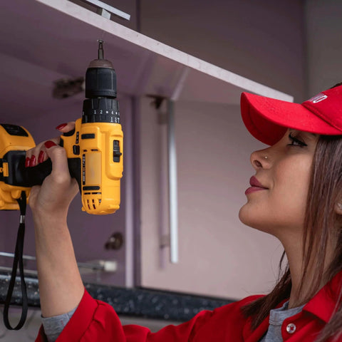 Person using a yellow power drill to repair kitchen cabinet, relevant for use with 113 Piece Bolts Nuts And Washers Assortment Kit Galvanized Iron Hardware Set For Home Repair.