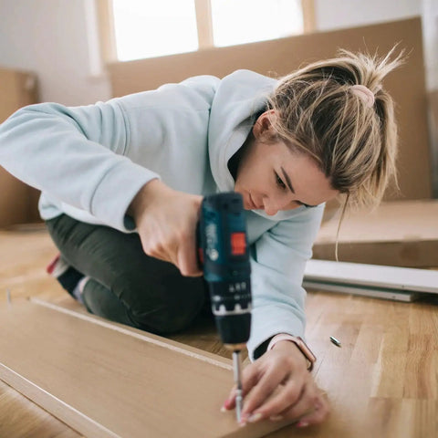 Person using drill with 4 Pcs Ball End Hex Screwdriver Bits 4mm H4.0 with 1/4 Inch Hex Shank for assembly on wooden floor