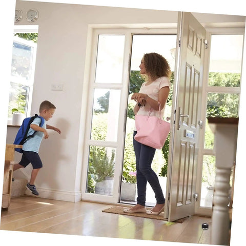 Woman and child entering a home with a two piece door silencer set cushions door impact, protects walls and hardwood floors visible on door.