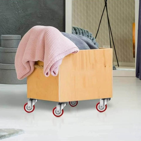 Wooden box with blankets on heavy duty swivel and rigid caster wheels with brakes, showing polyurethane casters and steel bracket design.