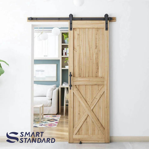 Natural wood door installed with 5 FT Heavy Duty Sturdy Sliding Barn Door Hardware Kit, Black, including handle and floor guide, I Shape Hanger.