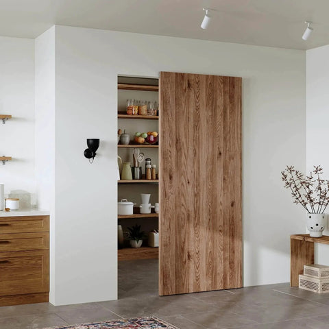 36" Concealed Sliding Barn Door Hardware Kit with Soft Close Mechanism for 28in Passage Opening, hidden sliding door displayed in kitchen.