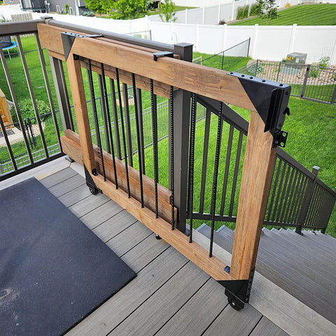 Sliding Gate Hardware Kit installed on wooden deck, featured in outdoor setting. Heavy Duty Slide Gate Kit with latch visible.