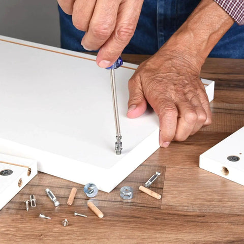 Man assembling furniture using Assorted 21 Piece Wooden Dowels Set M6 M8 M10 Hardwood Grooved Fluted Pins For Woodworking And Furniture DIY Carpentry Projects, Easy Glue Bond, Strong Joints, Ideal For Screw Holes And Repairs.