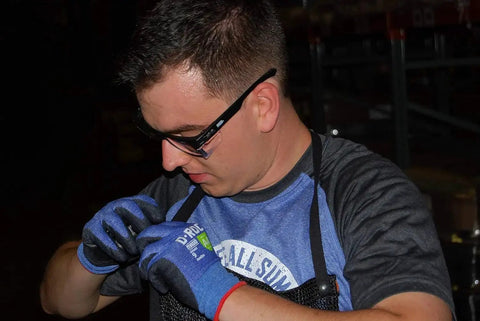 Person wearing ANSI Z87.1 Safety Glasses With Anti Fog UV Protection Clear Lens Side Shields working in a dark industrial setting.