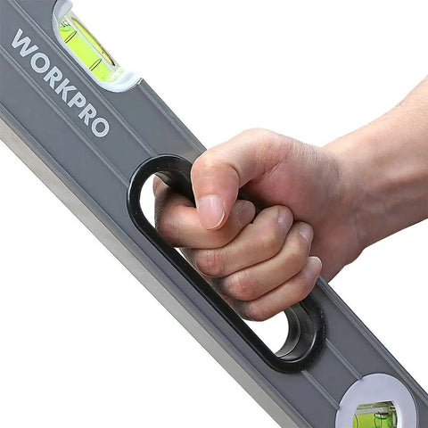 Hand holding Pro Grade 3 Piece Torpedo Level Set With Magnetic 9 Inch Level And Non Magnetic 16 Inch And 24 Inch Levels, Workpro