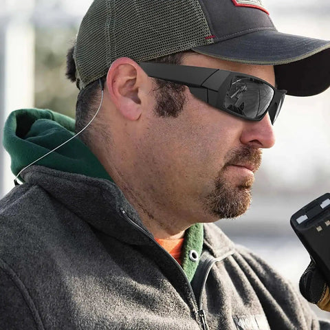 Man wearing Wraparound Rectangular Sunglasses For Men With UV400 And Z87 Rating Matte Black, outdoors in casual clothing.