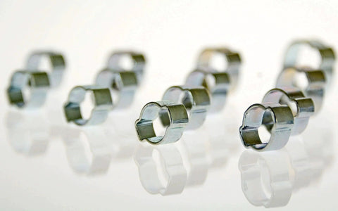 Close-up of zinc-plated steel clamps from Swordfish Two Ear Hose Clamp Assortment 125 Piece Kit By Swordfish Tools, showing smooth deburred edges.