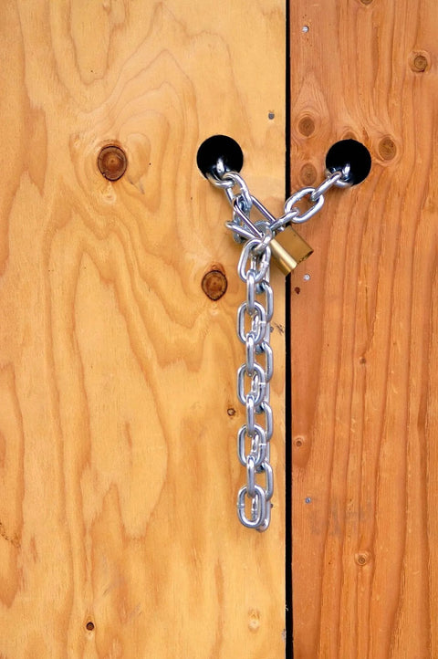 Image of ✝️ 699481 1/4" x 10' Zinc Plated Grade 30 Proof Coil Chain, Silver, securing a wooden door, highlighting smooth motion design.